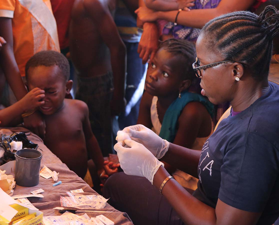 Nurse with Volta care preparing cotton wool with antiseptic before administering injection