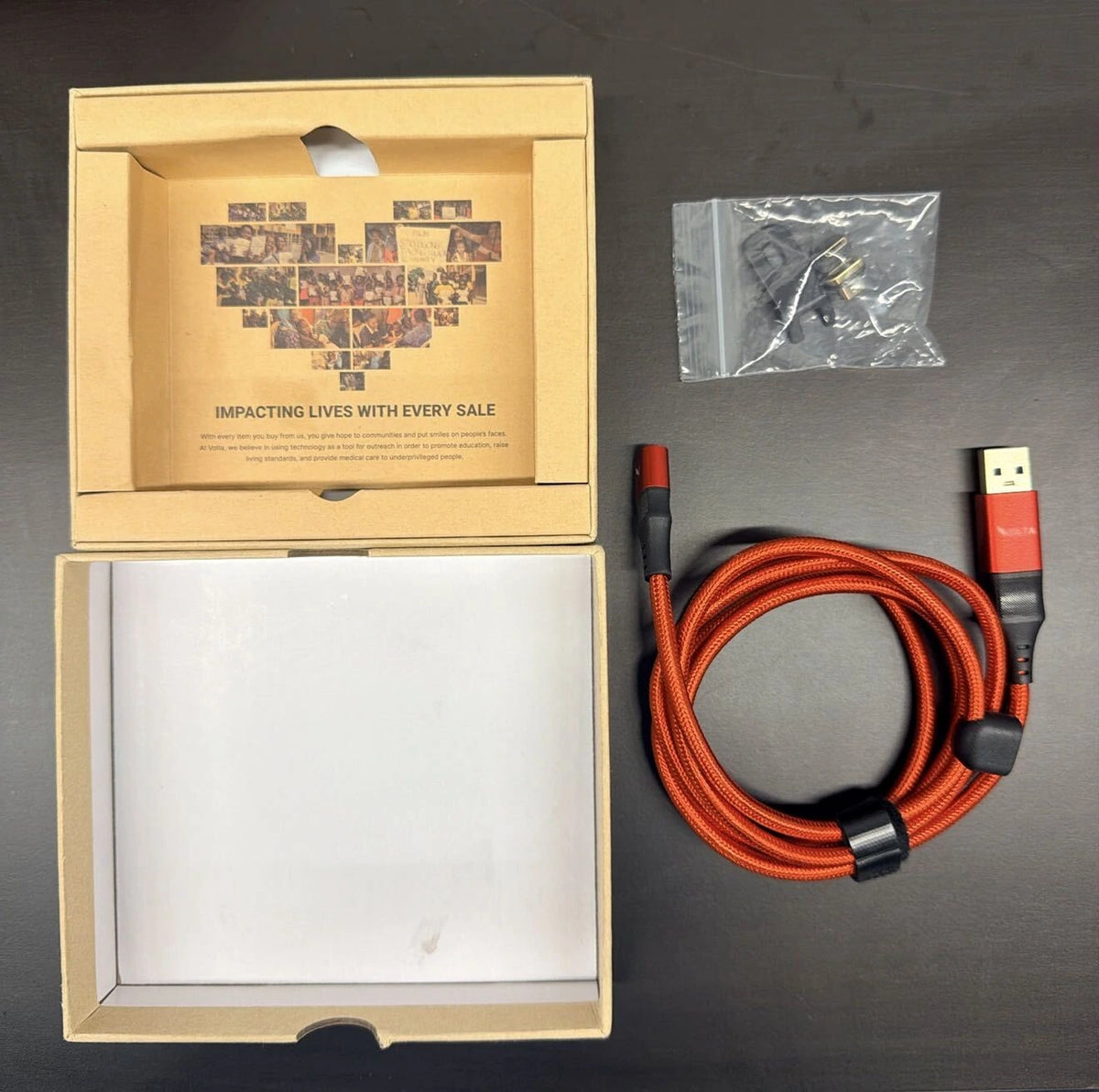 Volta box open showing cable, accessory pouch, and packaging inserts